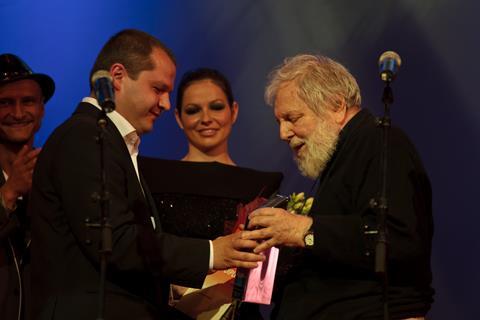 Veteran Romanian filmmaker Lucian Pintilie received the Excellence Award from young colleague Corneliu Porumboiu, with artistic director Mihai Chirilov (left) looking on